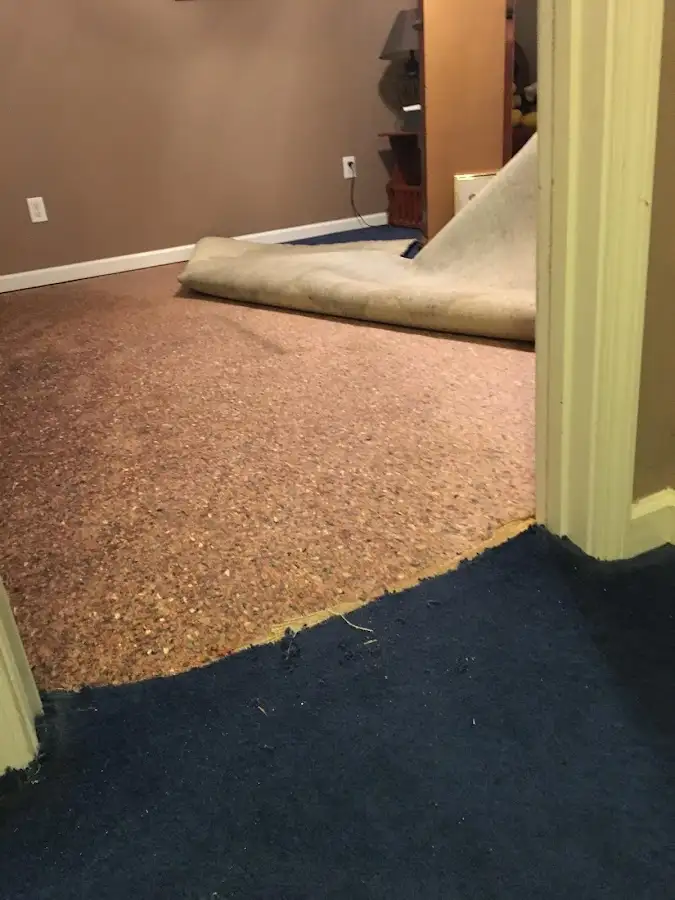 Carpet pad removal revealing water damage during Water Mitigation Services in Cabot