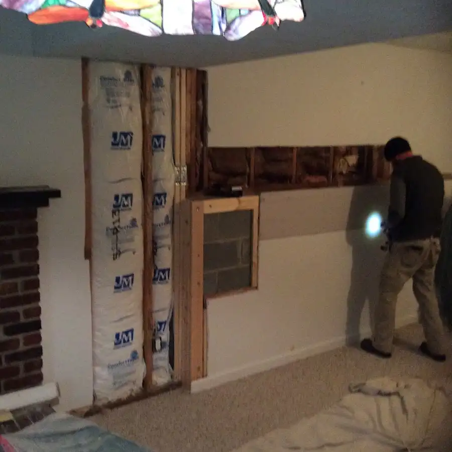 Restoration technician inspecting water damage in Cabot
